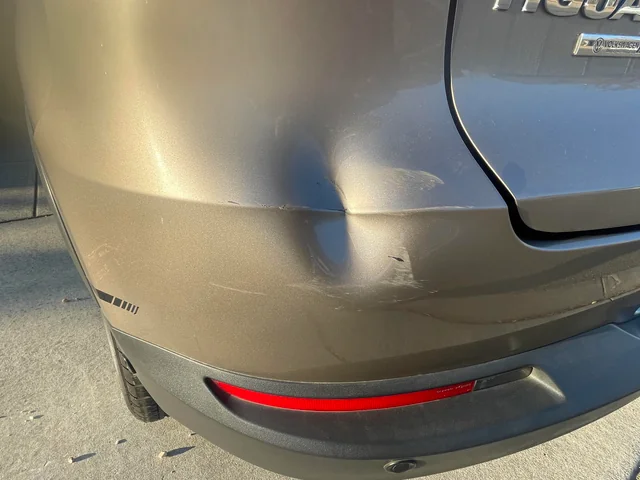 Car with dent needing to be fixed